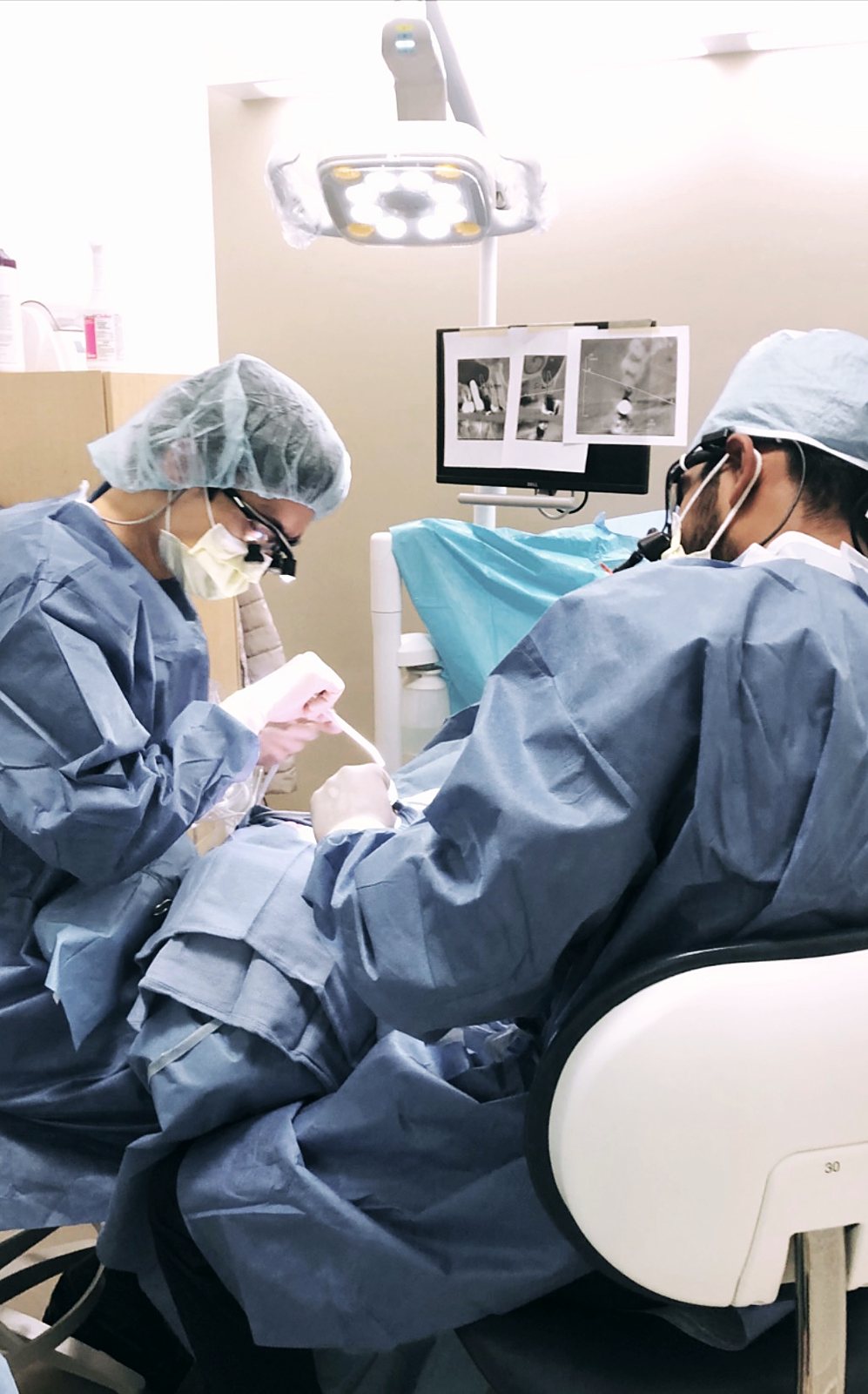 Dr. Parmar performing implant surgery with his team